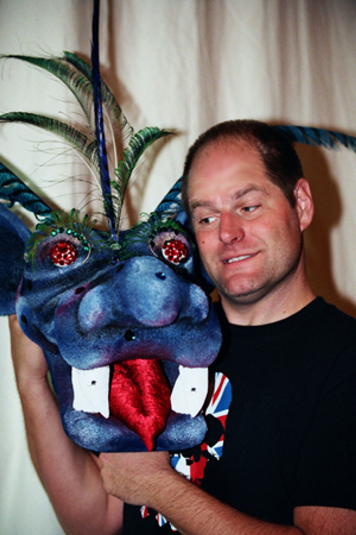Philip Solomon shows off the head of the Tsunami Dragon at 
