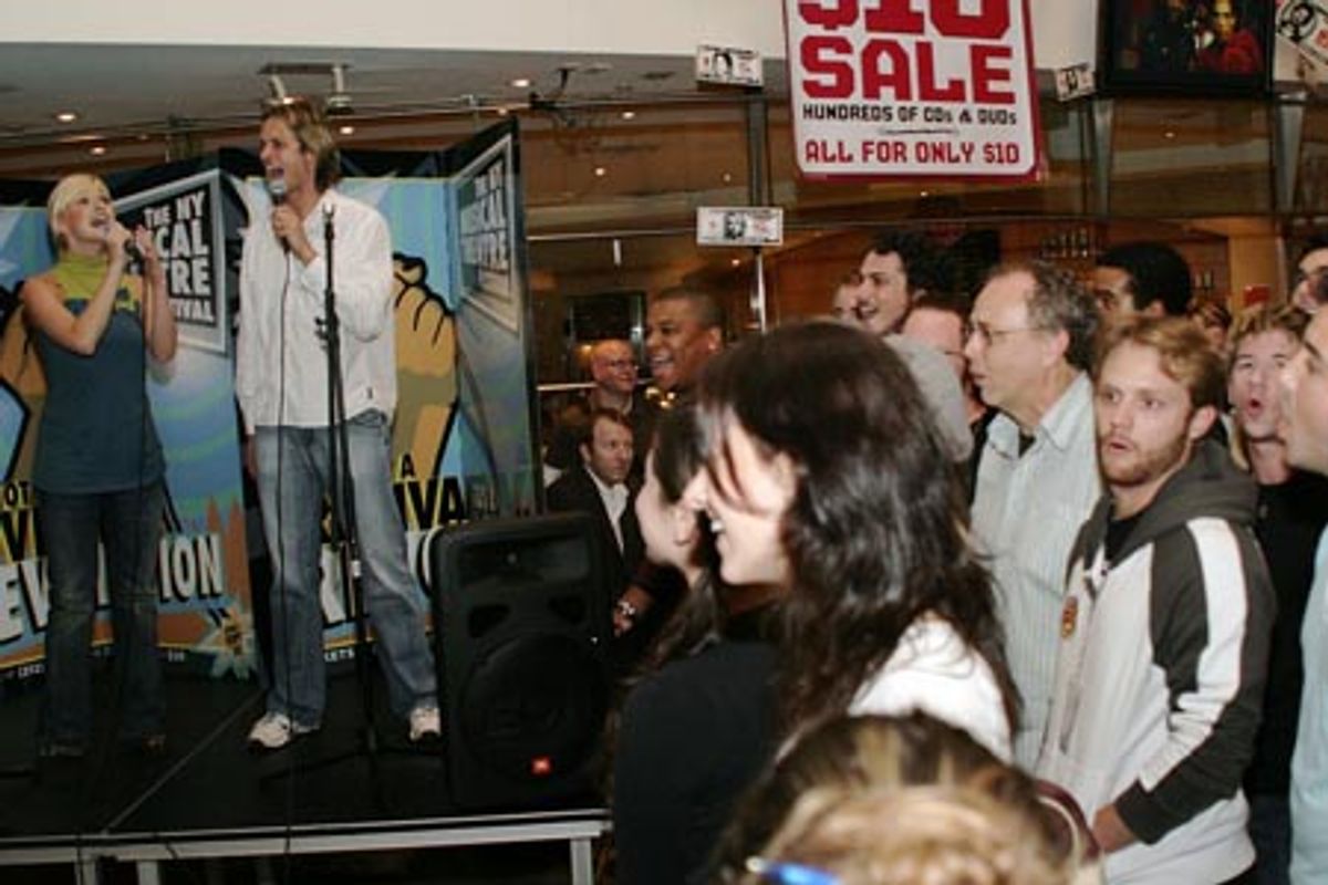 Hanna Liina-Vosa and Daniel Thornton singing 'One True Friend' from Angels joined by a chorus among the audience at 