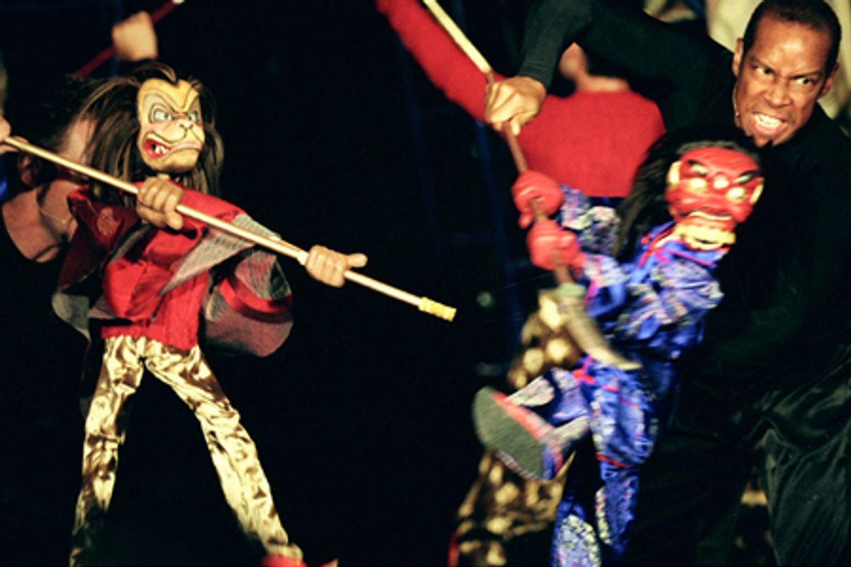 Shanon Stoeke and Kevyn Morrow manipulate the Monkey King and Demon puppets in a battle scene at 