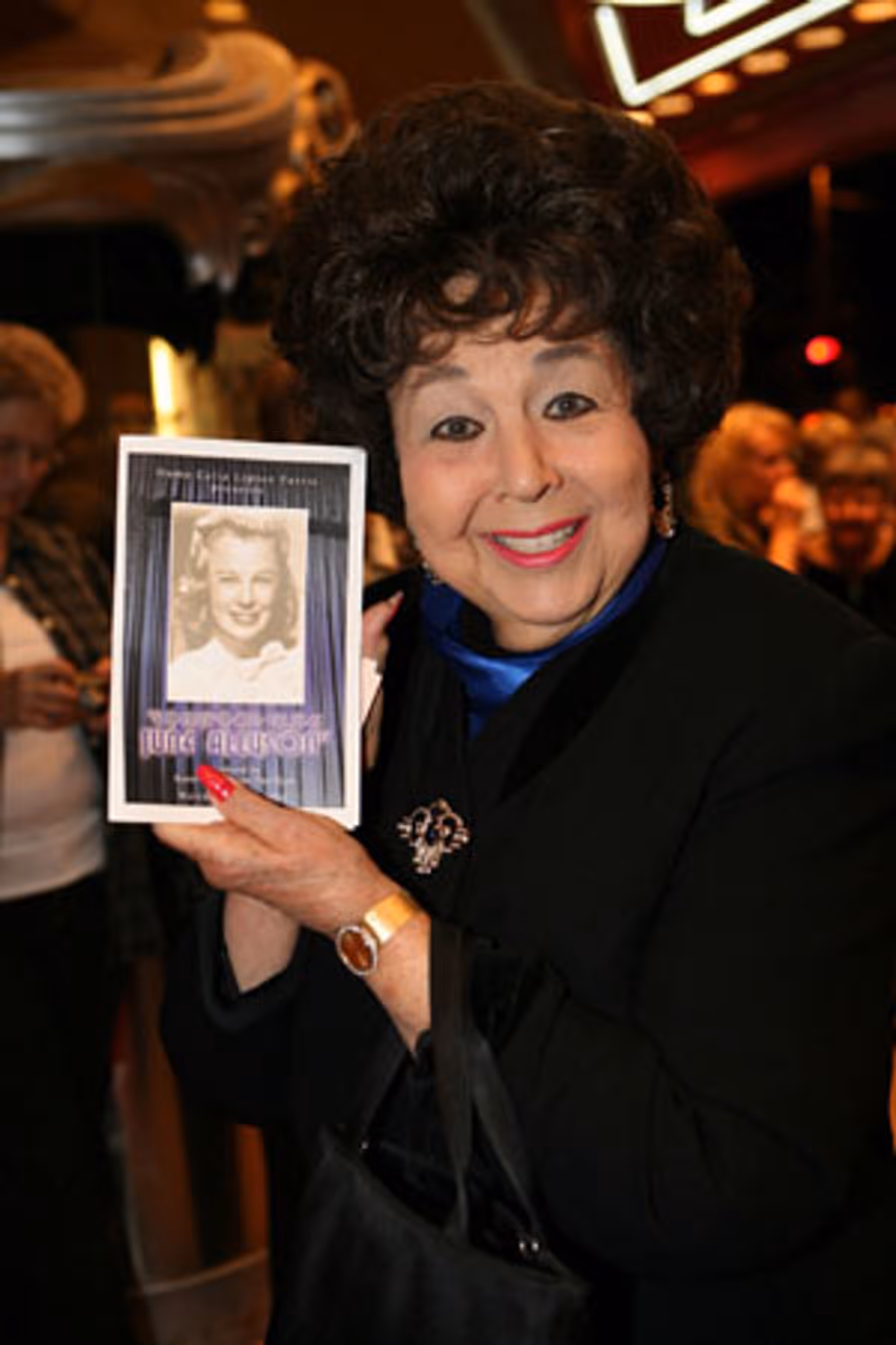 Jane Withers displays the evening's tribute program at June Allyson Tribute in L.A.
