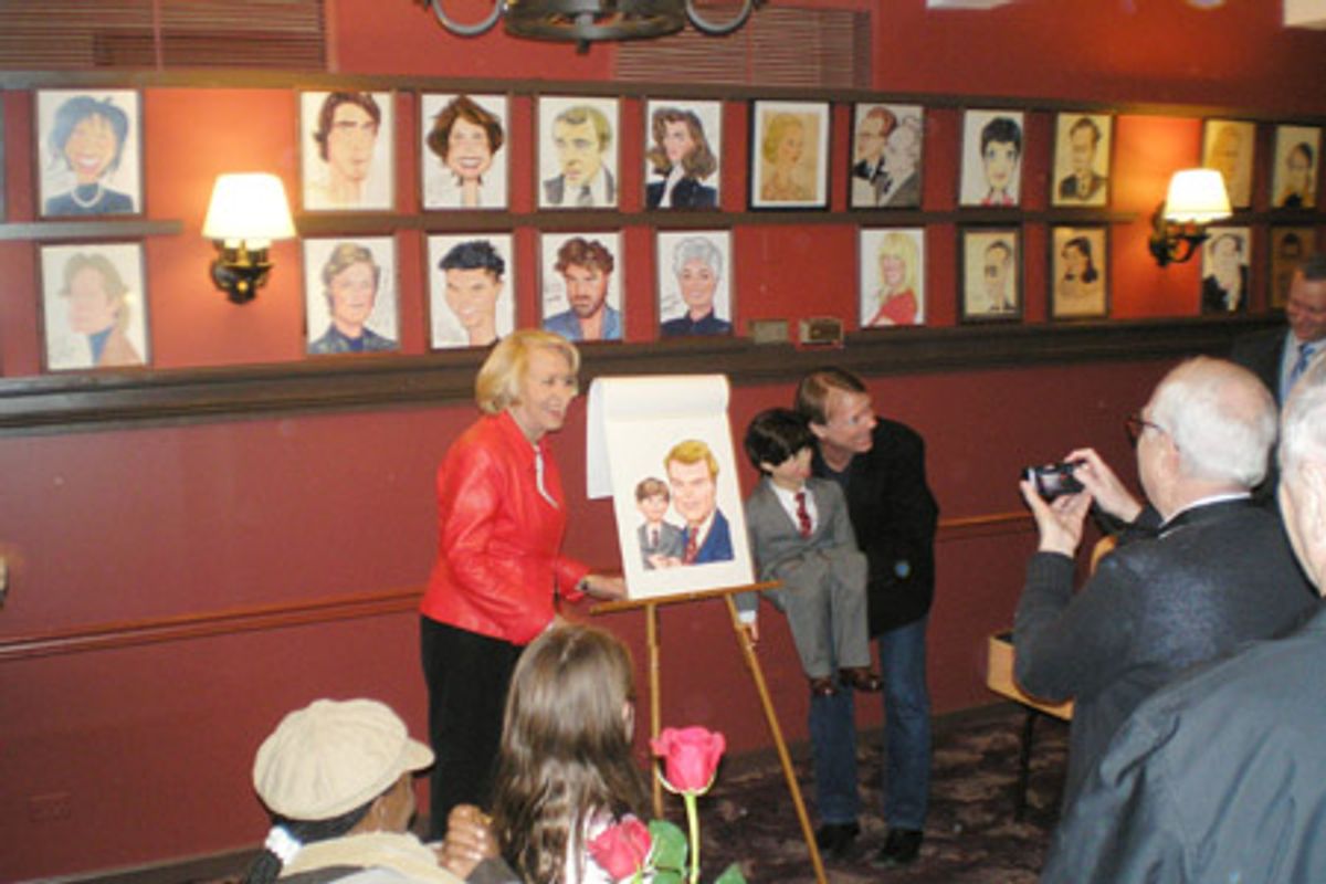 Liz Smith presents Jay Johnson and Bob with their caricature at 
