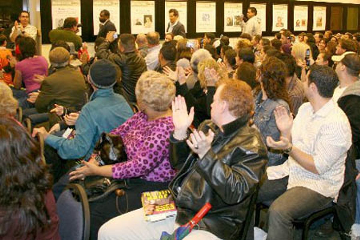 John Leguizamo enters a capacity filled room as the overflow crowd waits outside at 