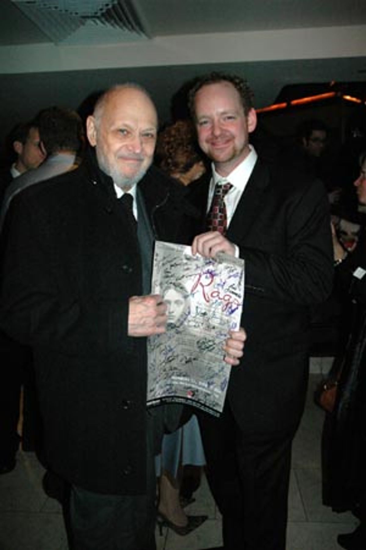 Jamie McGonnigal presenting Charles Strouse with a signed poster from the show at 