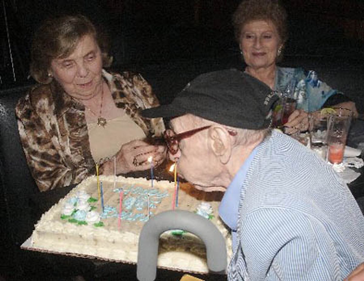 Bernie Bierman blowing out his candles
 at 