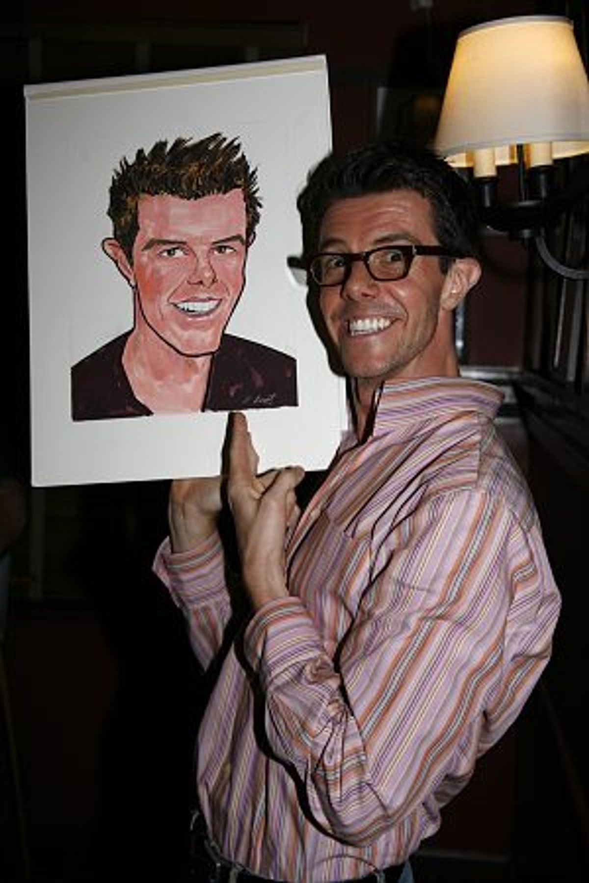 Gavin Lee signs his caricature at 