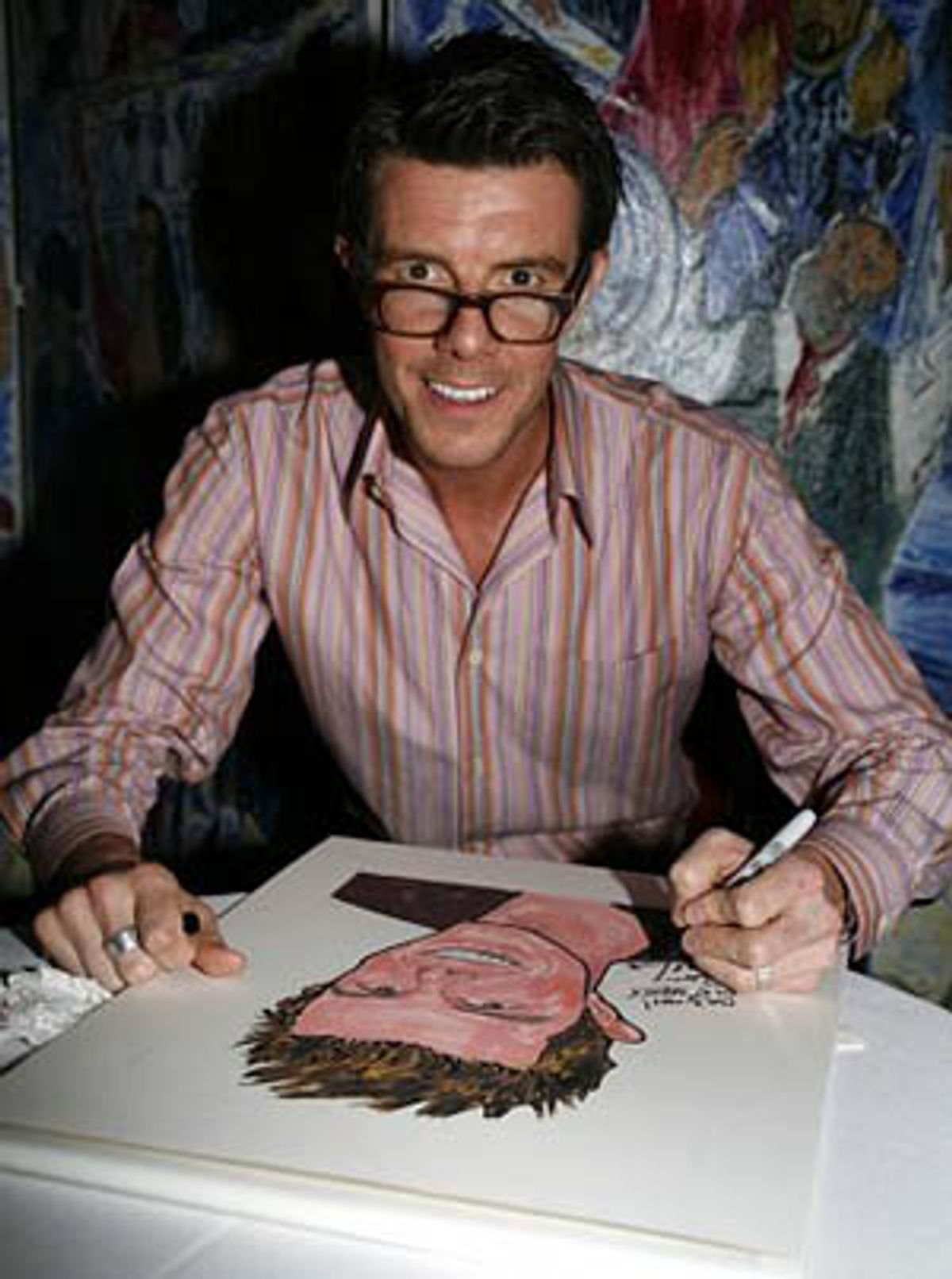 Gavin Lee signs his caricature at 