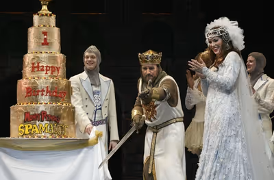 Peter Davison and Hannah Waddingham present the birthday cake at the curtain call Photo