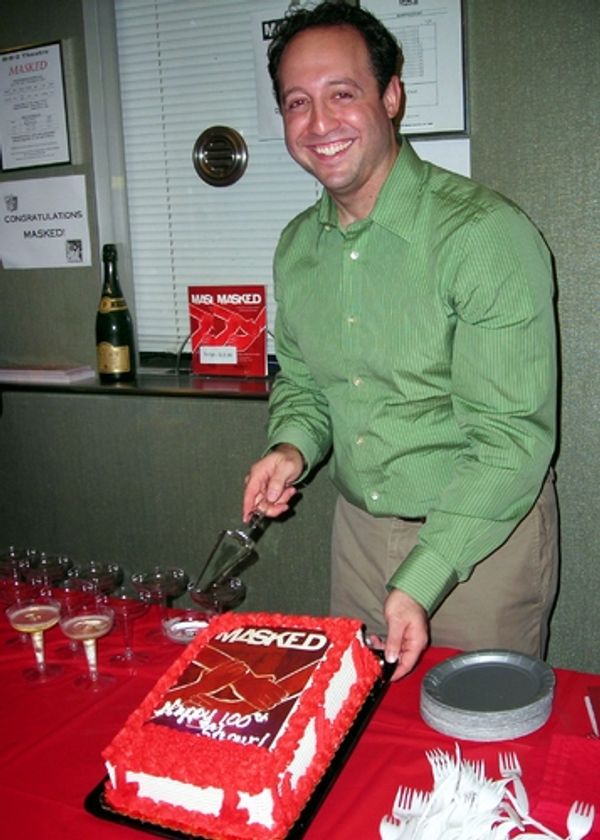 Producer Seth Goldstein cuts the Masked cake Photo