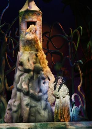 The Witch (Lisa Estridge) climbs up Rapunzel's (Anne Eisendrath) hair Photo