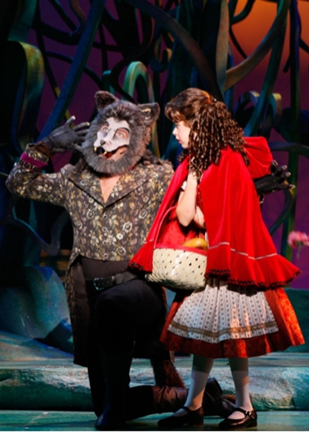 The Wolf (Michael Hunsaker) distracts Little Red Ridinghood (Ireland Woods) from her journey to Grandmother's house at 