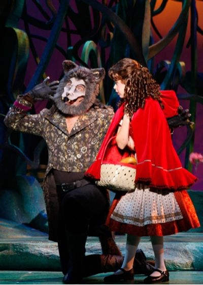 The Wolf (Michael Hunsaker) distracts Little Red Ridinghood (Ireland Woods) from her  Photo