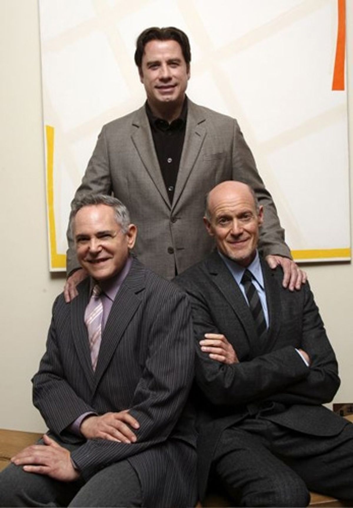 John Travolta with (seated l-r) Craig Zadan and Neil Meron at 