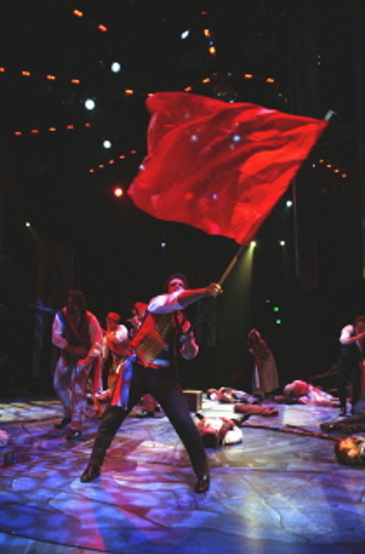 Charlie Brady as Enjorlas with the ensemble of Les MisÃ©rables at 