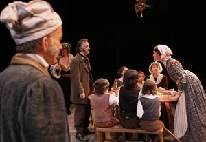 David Pichette as Scrooge, Richard Ziman as Spirit #2 and the cast as the Cratchits Photo