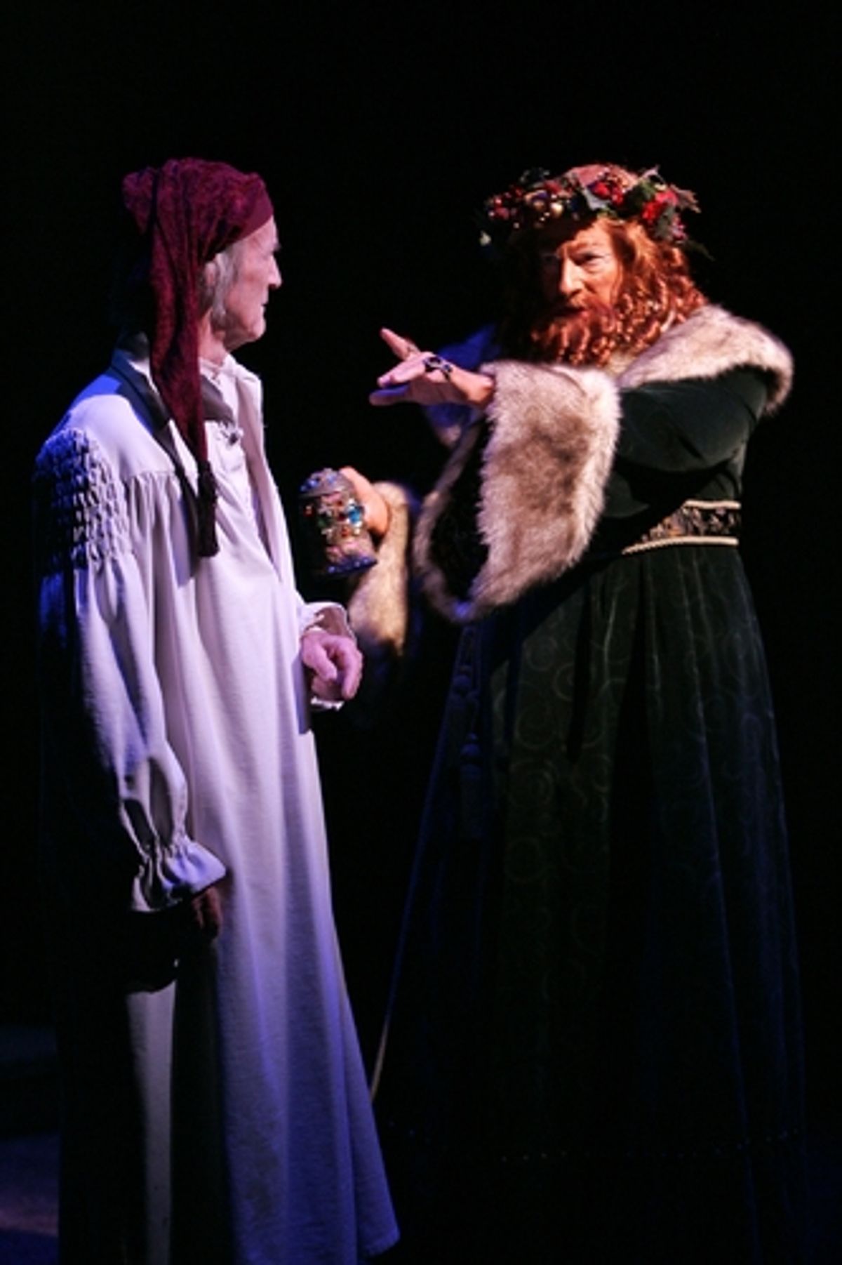 Scrooge is visited by the Spirit of Christmas Present (Timothy Landfield) at 