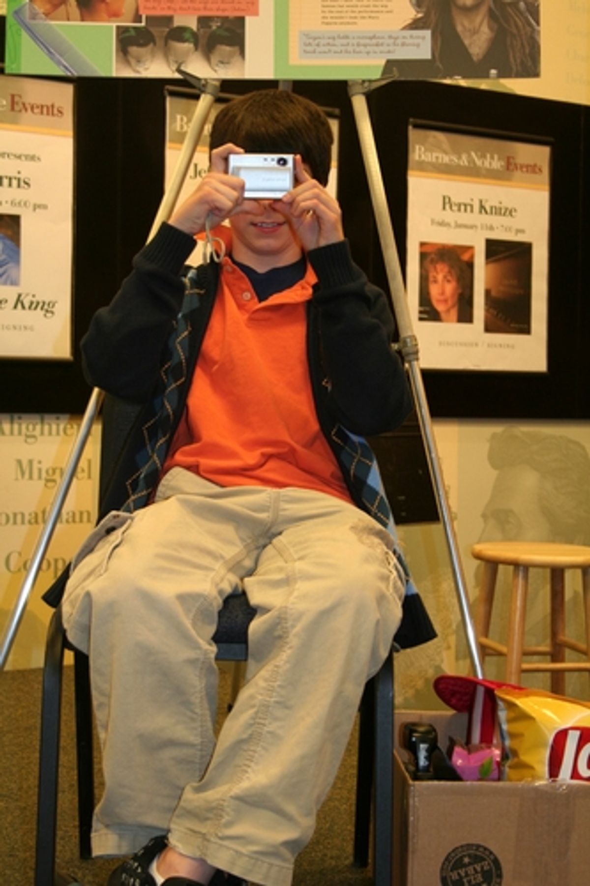 Henry Hodges showing some examples of what not to do in the theater in order to be curtious to the performers and other patrons.  Example, taking photos, video-taping, eating and wearing big hats. at Disney's Tom Schumacher Signs 'How Does the Show Go On?'