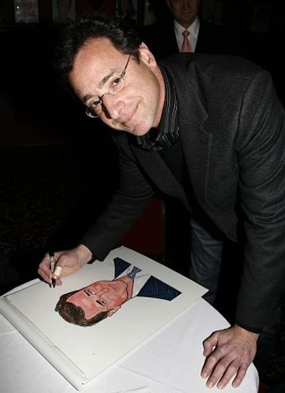 Bob Saget autographs his caricature
 Photo