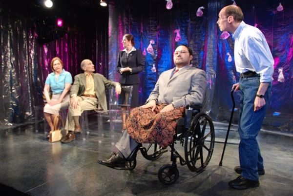 Orville Mendoza (in wheelchair) and John Daggett (standing) as Doug; background, l-r: Photo