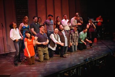 Christopher Sieber (second from left, front-row) hilariously belts the final notes of Photo