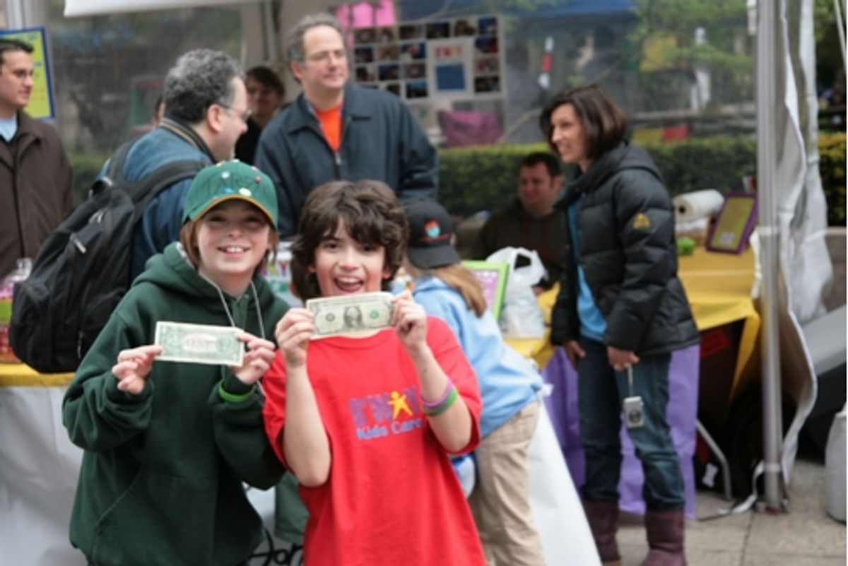 Broadway Kids Care members Dylan Riley Snyder and Zach Rand play around in front of their booth, which was collecting money for UNICEF and Shots 4 TOTS at 