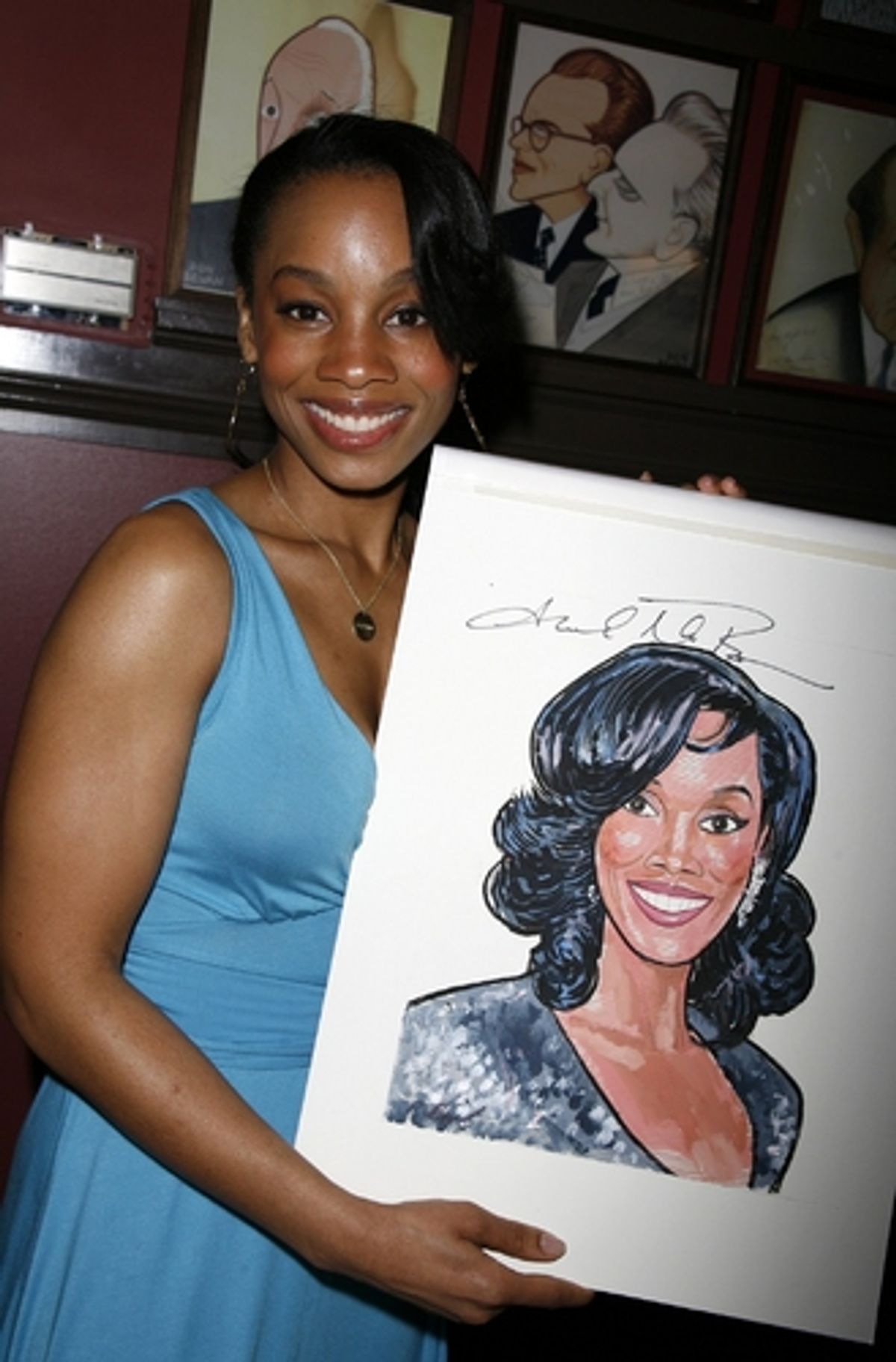 Anika Noni Rose with her caricature at 