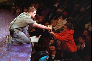 Carpenter Brian Munroe hands off a hydrolic control to an audience member
 Photo