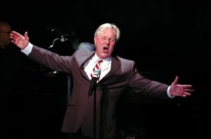 Walter Bobbie singing "You Mustn't Feel Discouraged" Photo