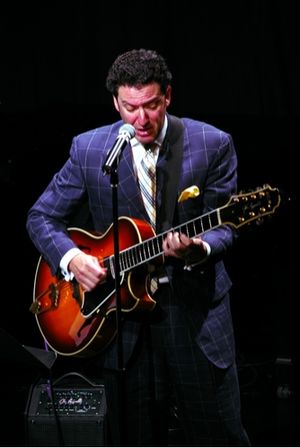 John Pizzarelli singing "Lucky to be Me" Photo