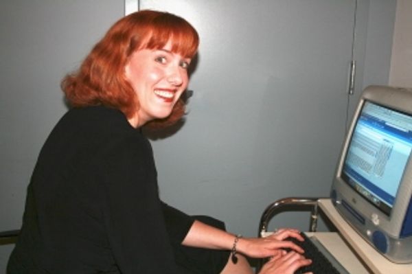 Capitol Steps member Jenny Corbett, checking her email in the green room before the s Photo