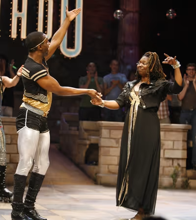 Whoopi Goldberg with cast member Andre Ward 
 Photo