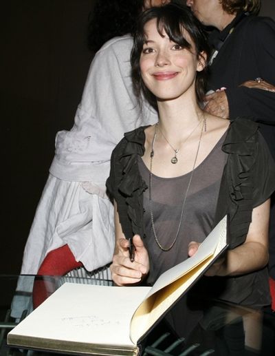 Rebecca Hall signing the Official book

 Photo