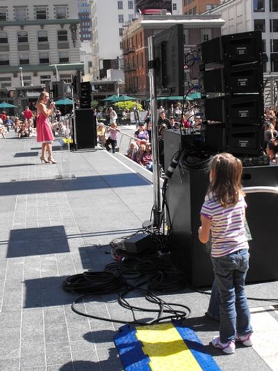 Young fan in the wings watching Caissie Levy as "Glinda" performing the song Popular  Photo
