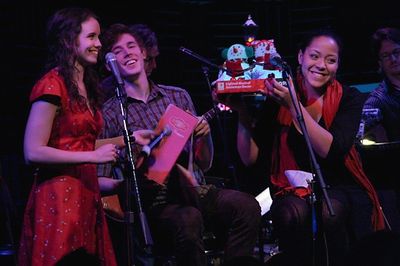 Phoebe Strole gives Christmas gifts to Morgan Karr and Lilli Cooper Photo