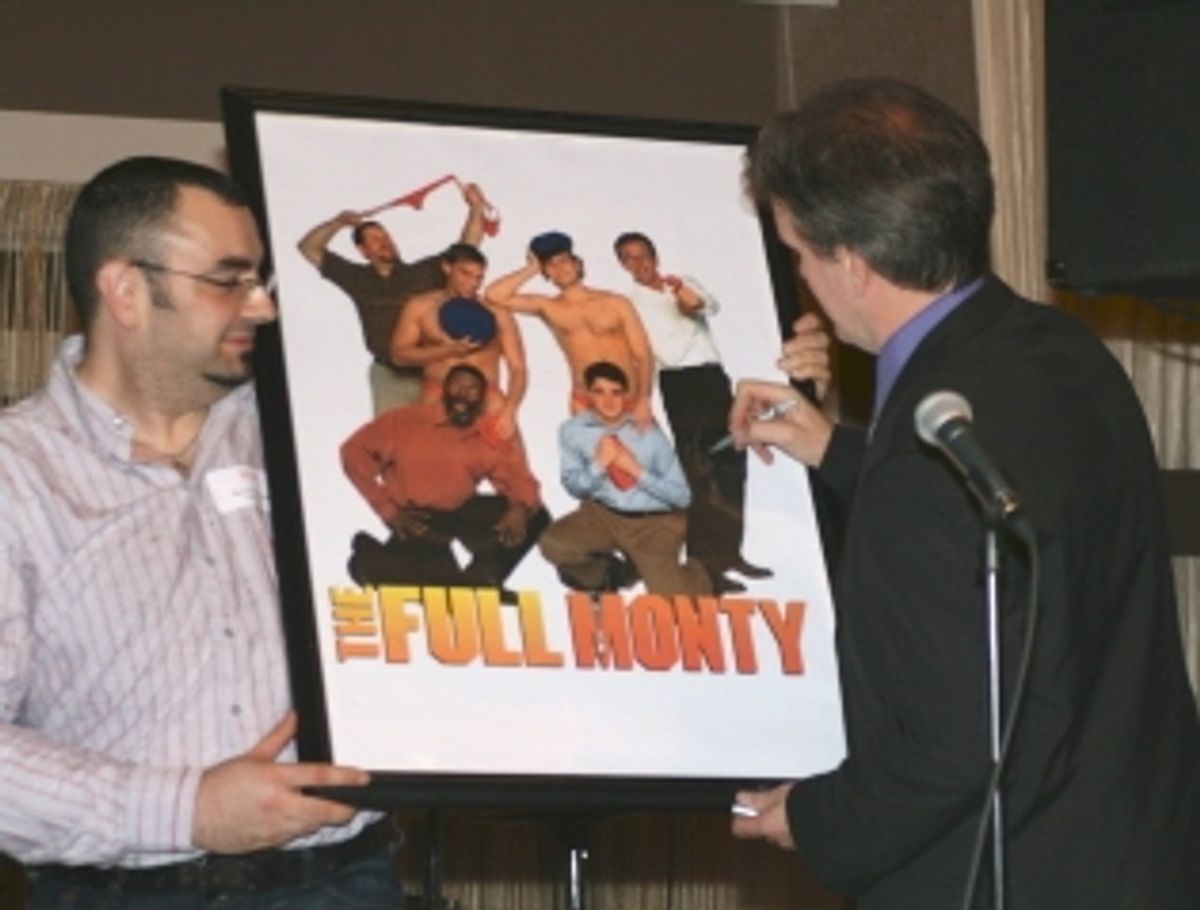 George Dvorsky signs The Full Monty poster for the live auction while former employee Mike Ceceri volunteers to lend a hand at 