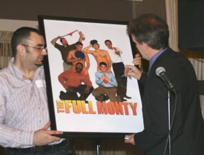 George Dvorsky signs The Full Monty poster for the live auction while former employee Photo