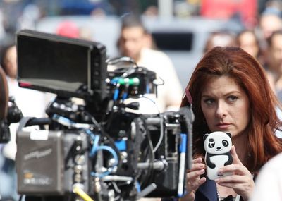 Debra Messing photographing 'Naked Cowboy'  Photo