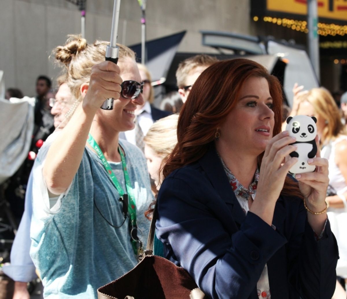 Debra Messing photographing 'Naked Cowboy'  at 