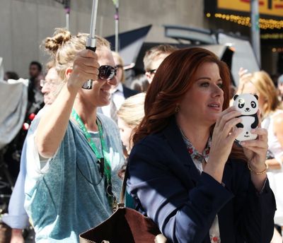 Debra Messing photographing 'Naked Cowboy'  Photo
