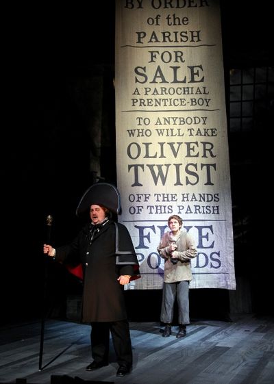 Eric Hoffmann as Mr. Bumble, a parish beadle and (rear) Quentin McCuiston as Oliver T Photo