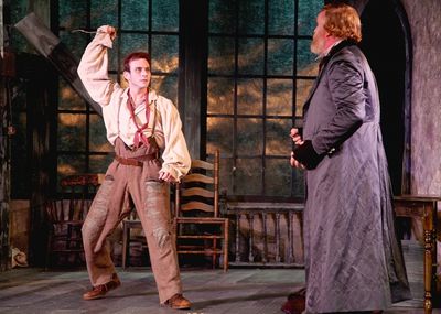 The Artful Dodger played by Robbie Collier Sublett threatens Fagin, the receiver of s Photo