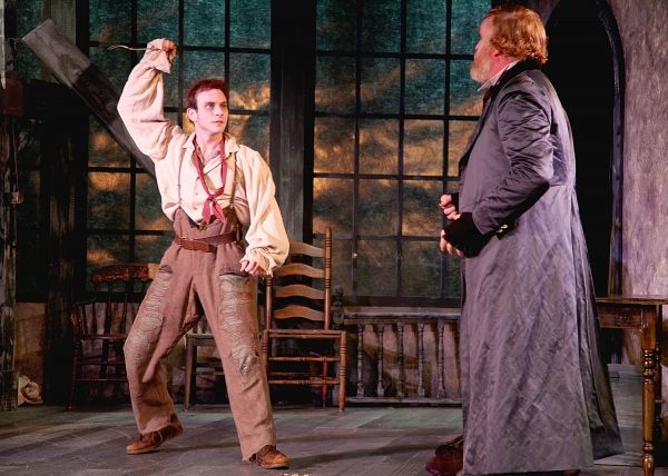 The Artful Dodger played by Robbie Collier Sublett threatens Fagin, the receiver of s Photo