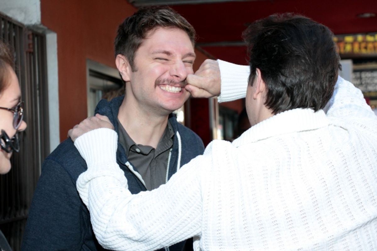 Matthew Saldivar checks a fan's stache at 