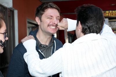 Matthew Saldivar checks a fan's stache Photo