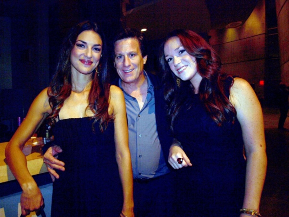 Backup singers Laura Carbonell and Alison Cusano pose with an audience member at 