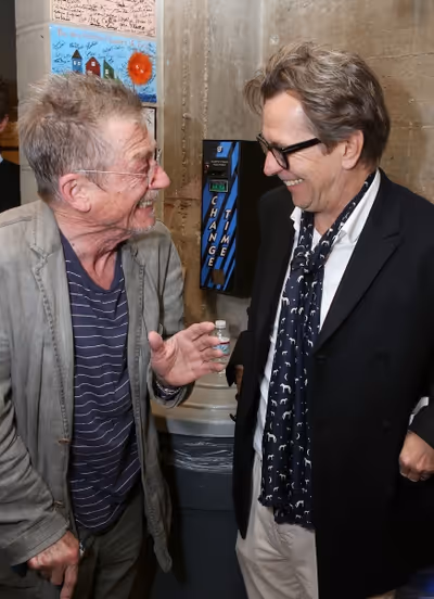 From left, cast member John Hurt is greeted by actor Gary Oldman backstage after the  Photo