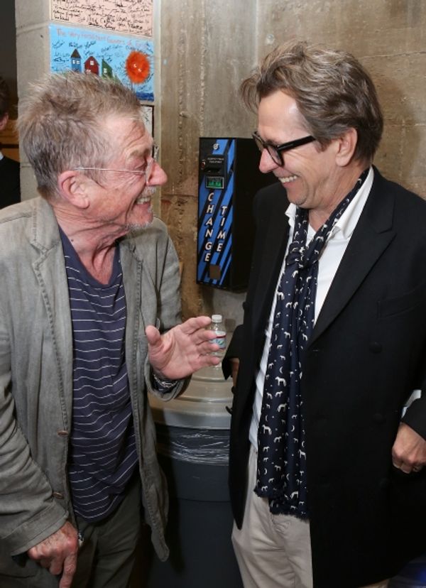 From left, cast member John Hurt is greeted by actor Gary Oldman backstage after the  Photo