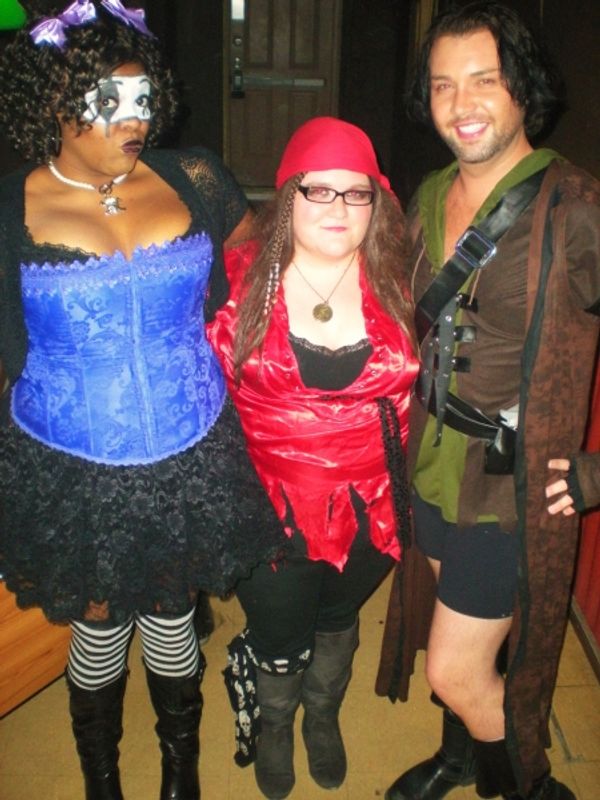 Jennifer Whitcomb-Oliva and Bryce Conner flank an unidentified reveler. Photo