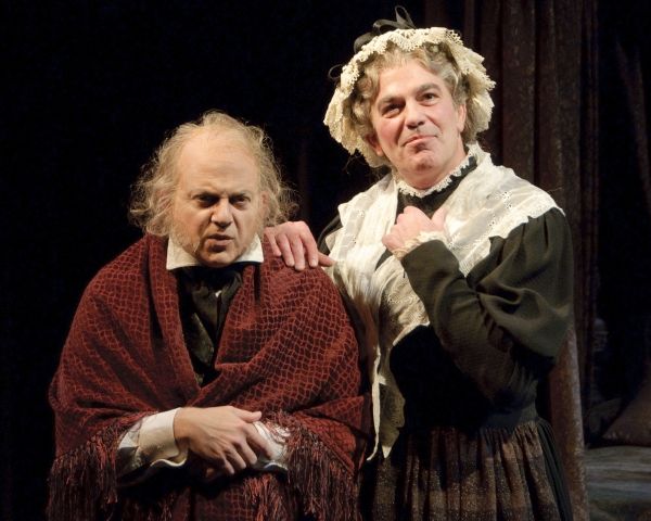 Jeffrey Bean as Ebenezer Scrooge and John Feltch as Mrs. Dilber Photo