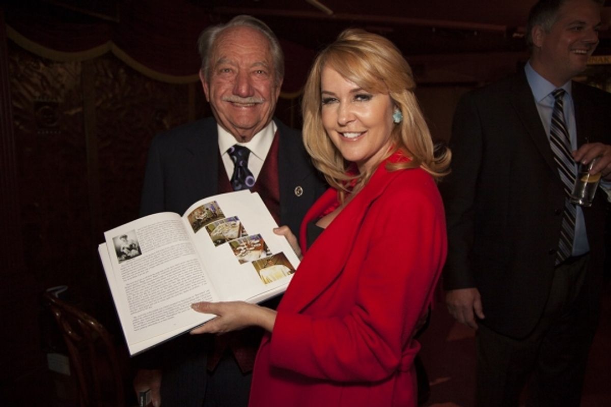 Milt Larsen shows a member of magic royalty, Erin Murphy, her place in his book as Tabitha in 'Bewitched.' at 
