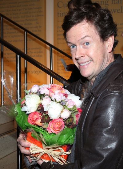 Dylan Baker with flowers for his wife Photo